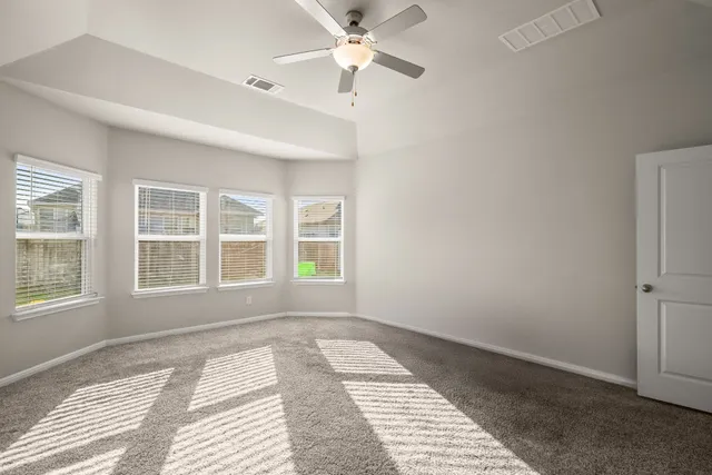 a bedroom with a large bed and a window