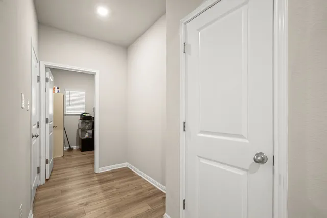 a view of a hallway with wooden shelves