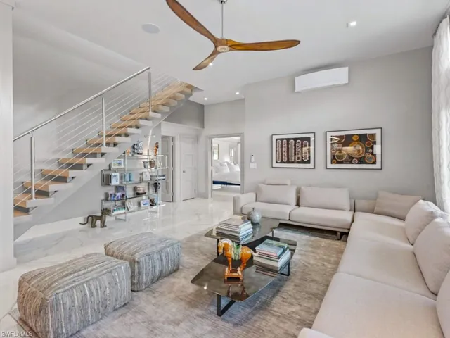 a bedroom with a bed and painting on the wall