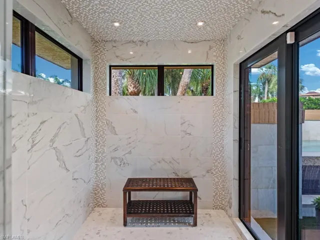 a bathroom with a granite countertop sink mirror vanity and toilet