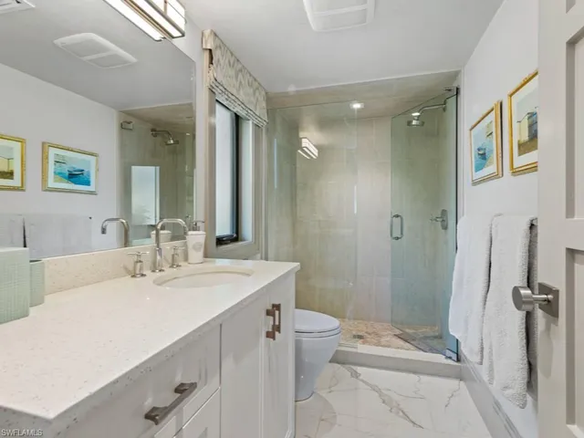 a bathroom with a shower sink and mirror