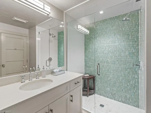 a spacious bedroom with a bed and a flat screen tv