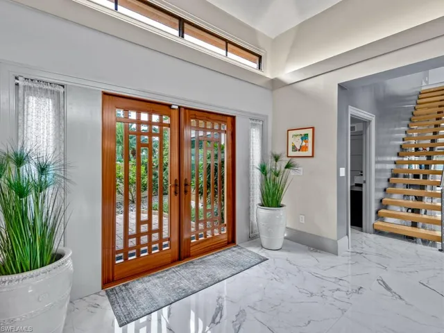 a view of an entryway with wooden floor and door