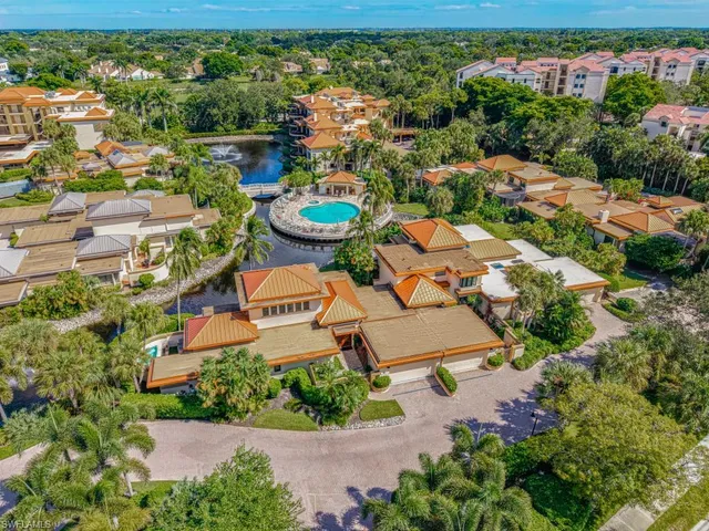 an aerial view of a residential apartment building with a yard and plants