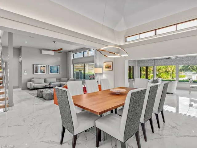 a view of a dining room with furniture and a large window