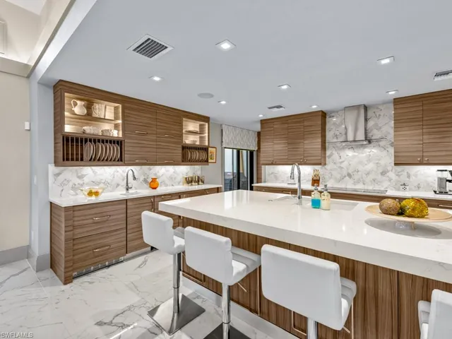 a kitchen with stainless steel appliances granite countertop a sink and a stove