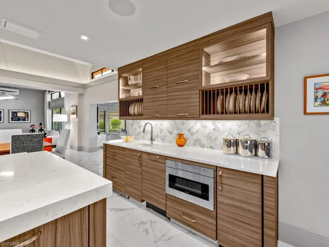 a kitchen with stainless steel appliances a sink stove and cabinets