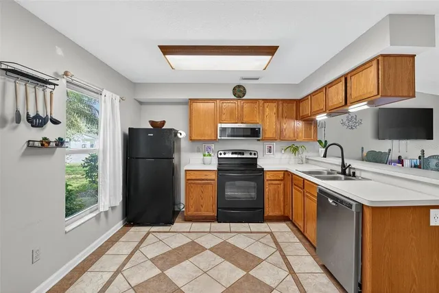 a kitchen with stainless steel appliances granite countertop a refrigerator stove and sink