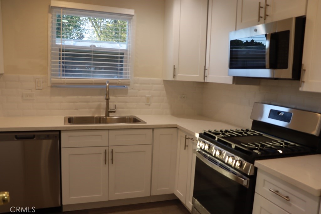 6865 Morro Road, Unit A Atascadero, CA 93422 - Photo 6 of 41 a kitchen with stainless steel appliances granite countertop a sink stove and microwave