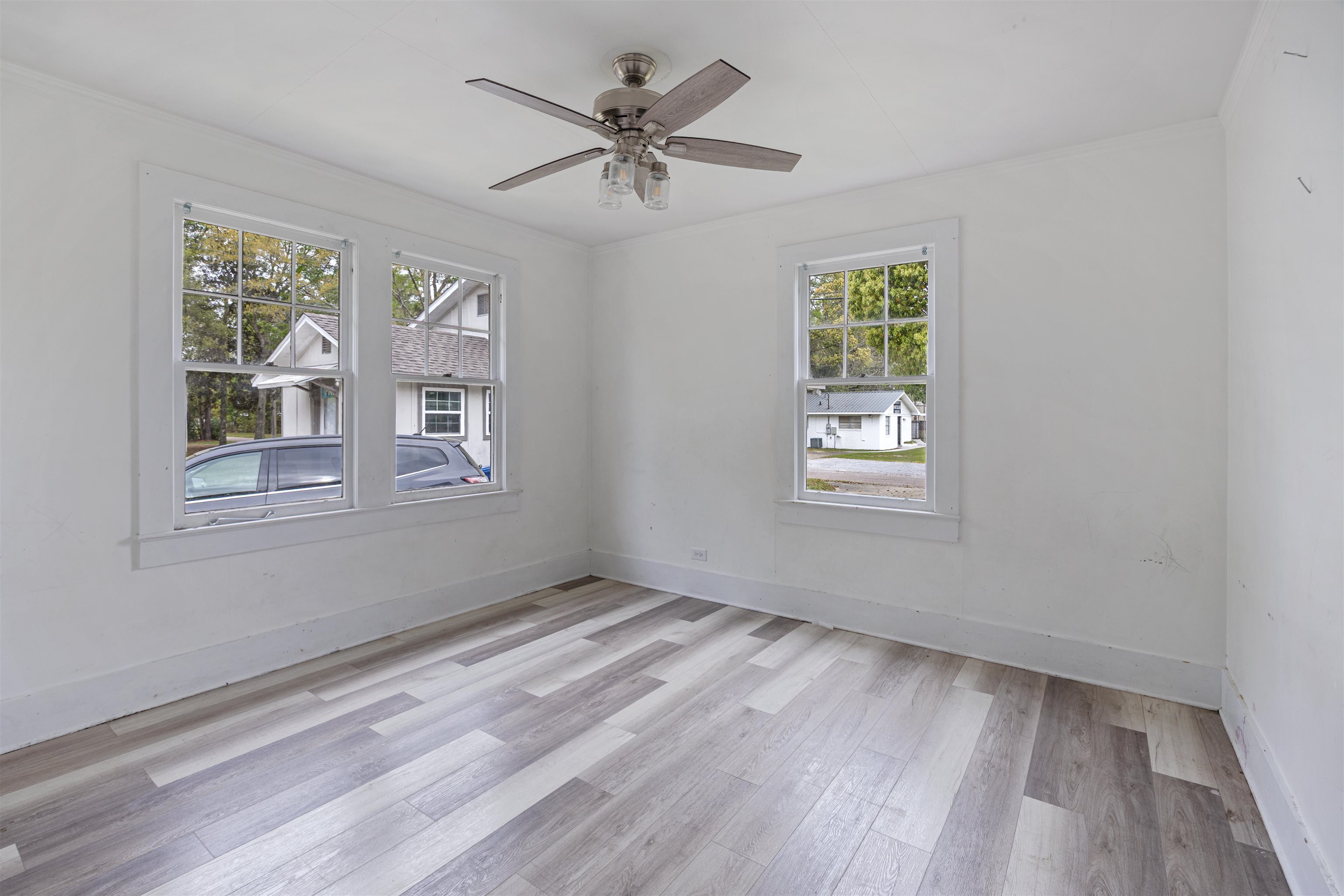 112 South Juniper Street Foley, AL 36535 - Photo 26 of 64 Spare room featuring light wood-style floors, a ceiling fan, and crown molding