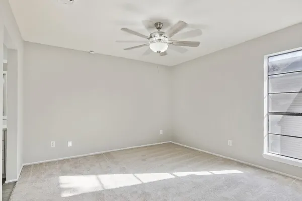 a view of a livingroom with a ceiling fan & a ceiling fan