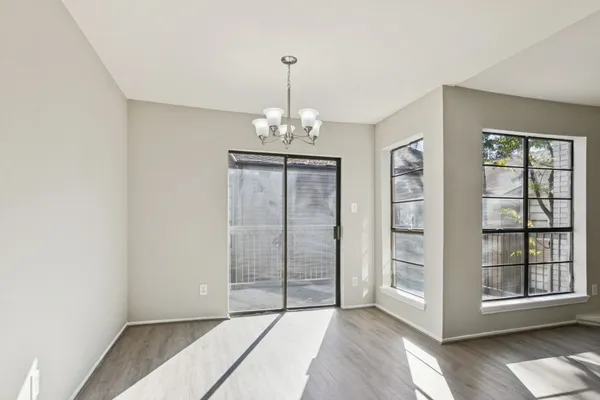 an empty room with windows and entryway