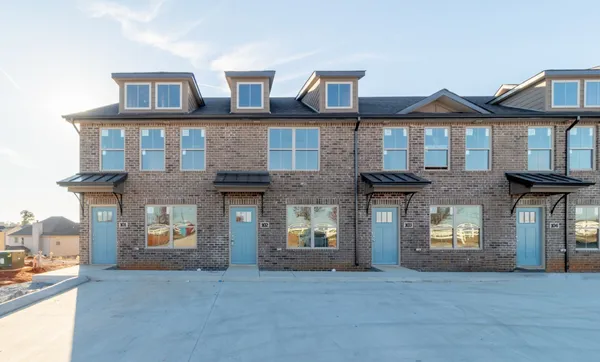 a view of a brick house with many windows