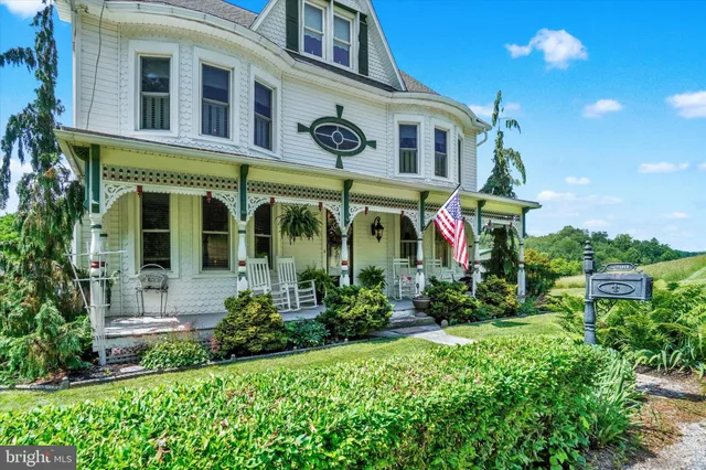 a view of house with yard and green space