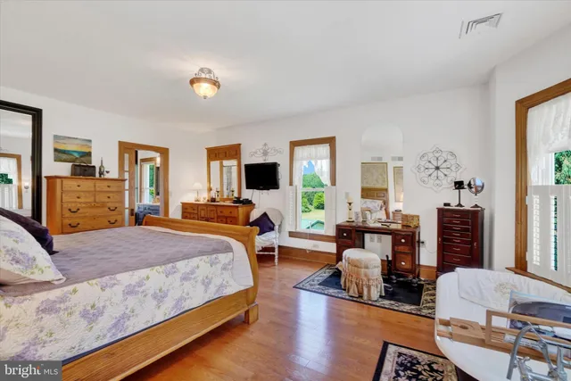 a bedroom with furniture and a chandelier