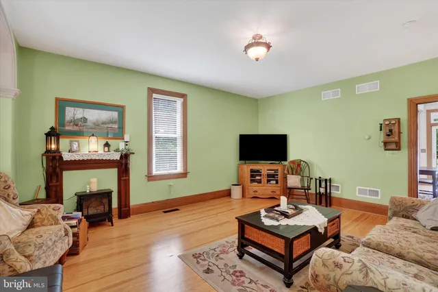 a view of a dining room with furniture and a chandelier