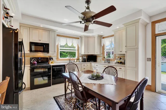 a kitchen with granite countertop a sink a stove and cabinets