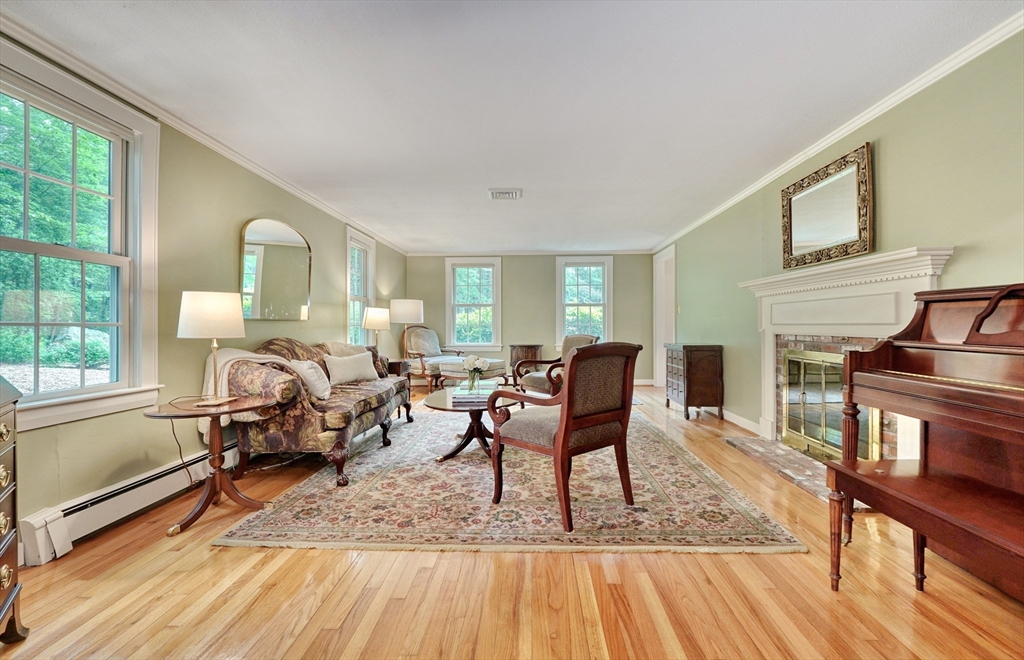 43 Old Pickard Road Concord, MA 01742 - Photo 11 of 27 a living room with furniture a fireplace and wooden floor