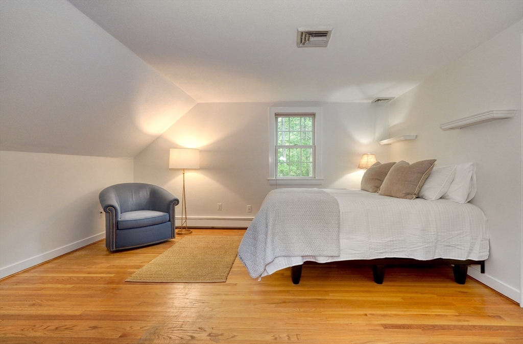 43 Old Pickard Road Concord, MA 01742 - Photo 17 of 27 a bedroom with a bed and a chair