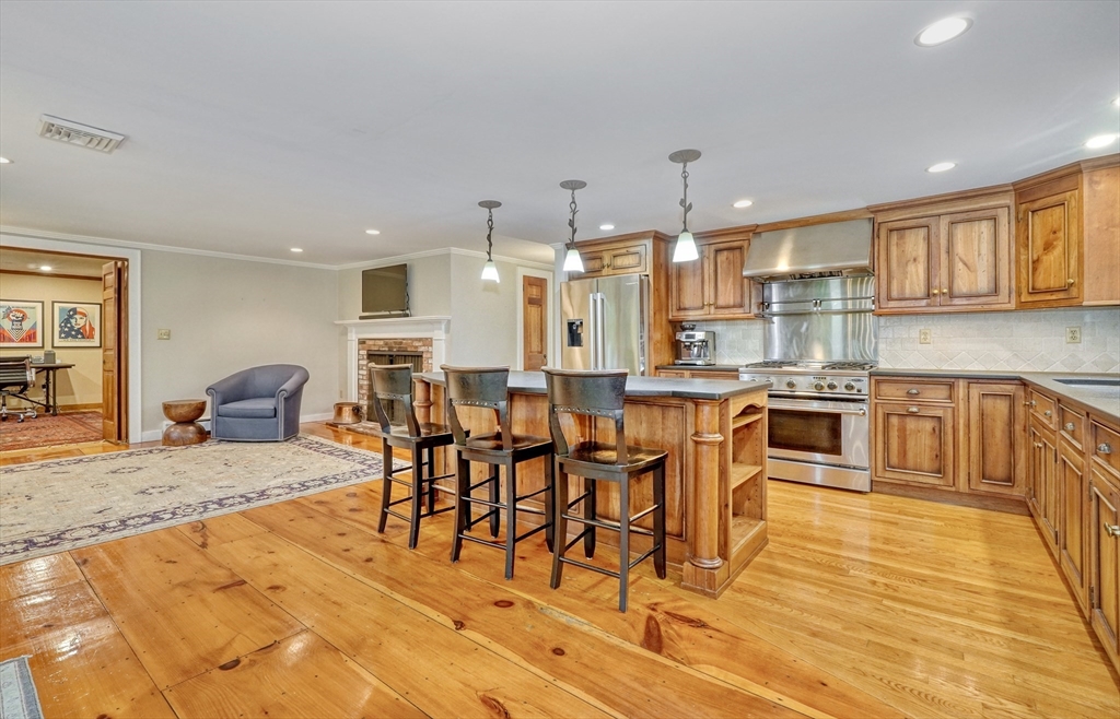 43 Old Pickard Road Concord, MA 01742 - Photo 8 of 27 a large kitchen with a table and chairs in it