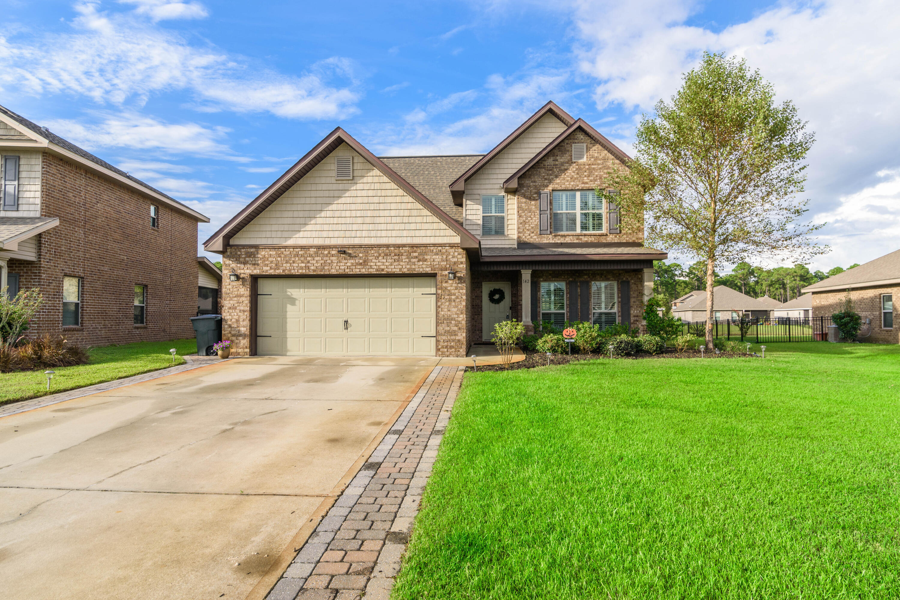 a front view of a house with garden