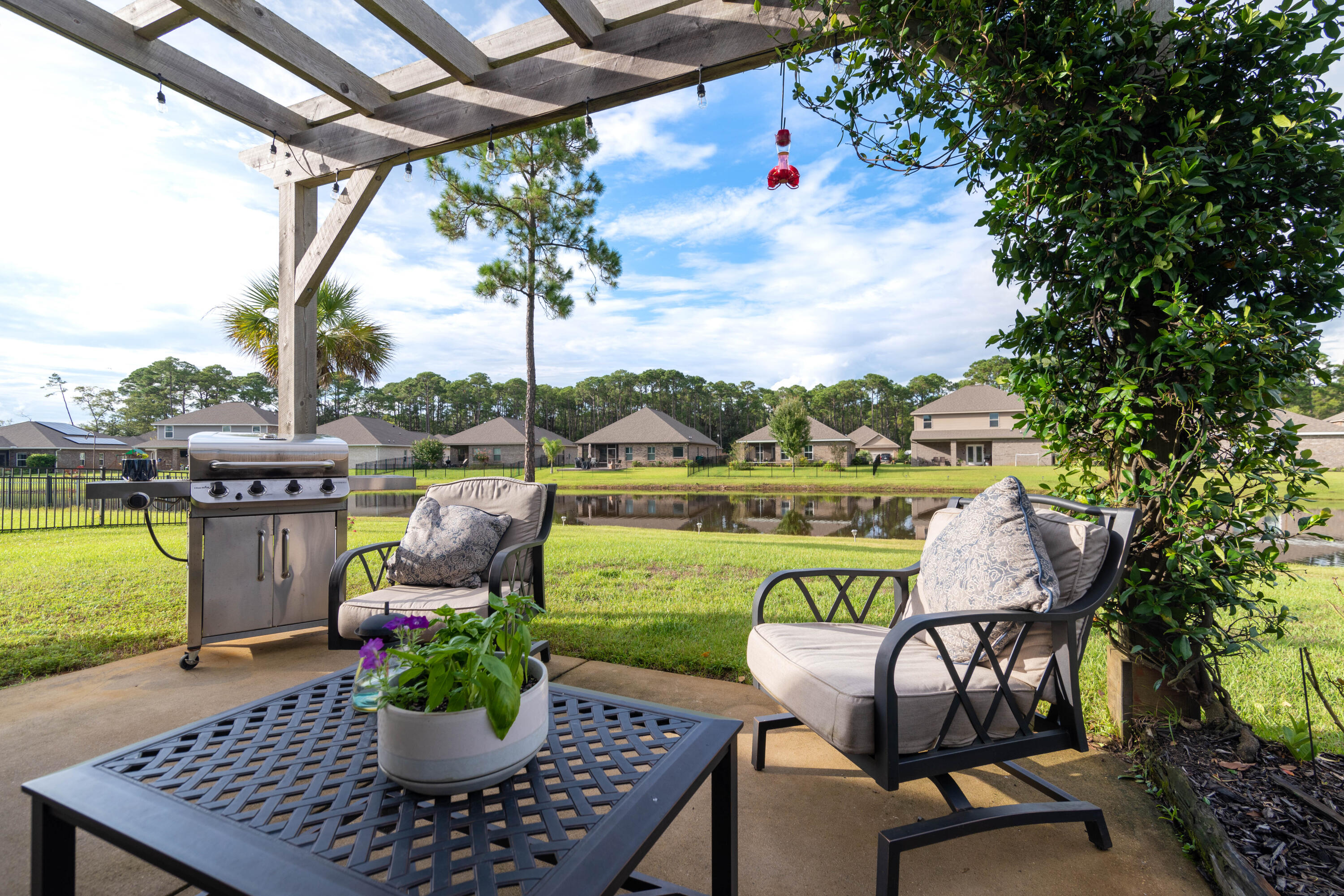 142 Pin Oak Loop Santa Rosa Beach, FL 32459 - Photo 12 of 56 a view of a chairs and table in the patio