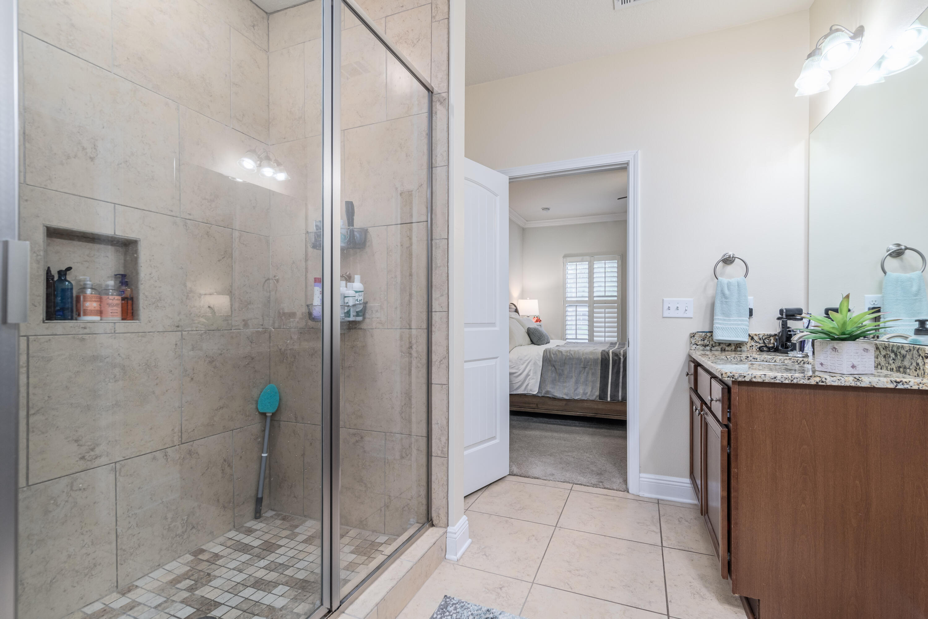 142 Pin Oak Loop Santa Rosa Beach, FL 32459 - Photo 22 of 56 a en suite bathroom with a granite countertop sink a toilet and shower