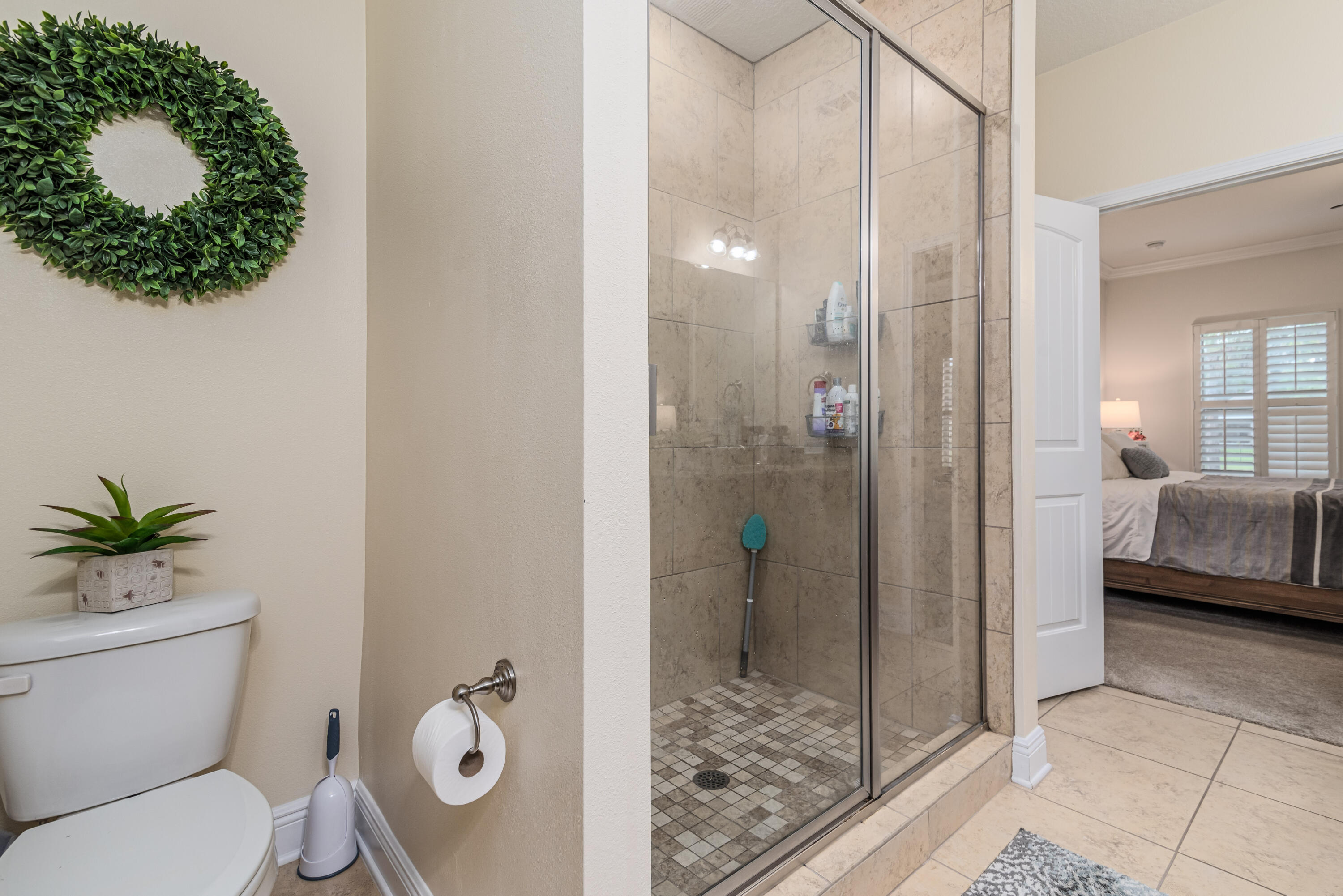 142 Pin Oak Loop Santa Rosa Beach, FL 32459 - Photo 24 of 56 a bathroom with a toilet a sink and glass door