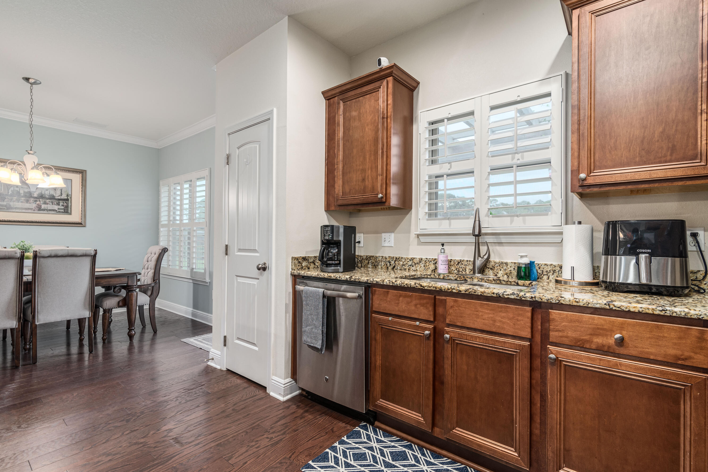 142 Pin Oak Loop Santa Rosa Beach, FL 32459 - Photo 35 of 56 a kitchen with stainless steel appliances granite countertop a stove a sink dishwasher and a refrigerator with wooden floor