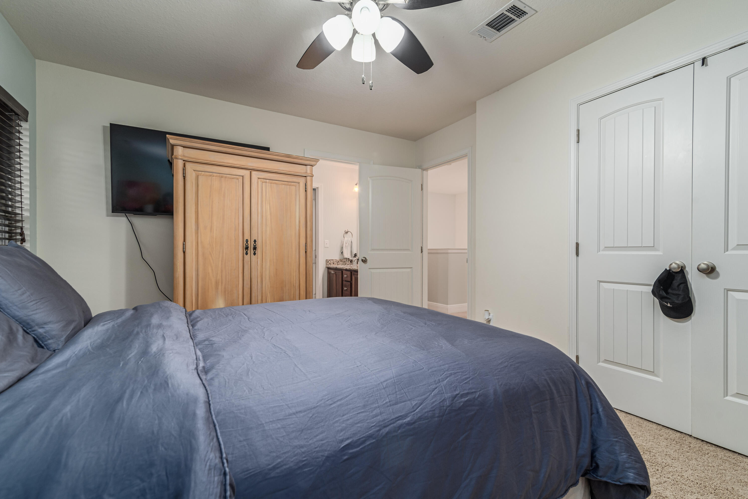 142 Pin Oak Loop Santa Rosa Beach, FL 32459 - Photo 45 of 56 a bedroom with a bed and a chandelier
