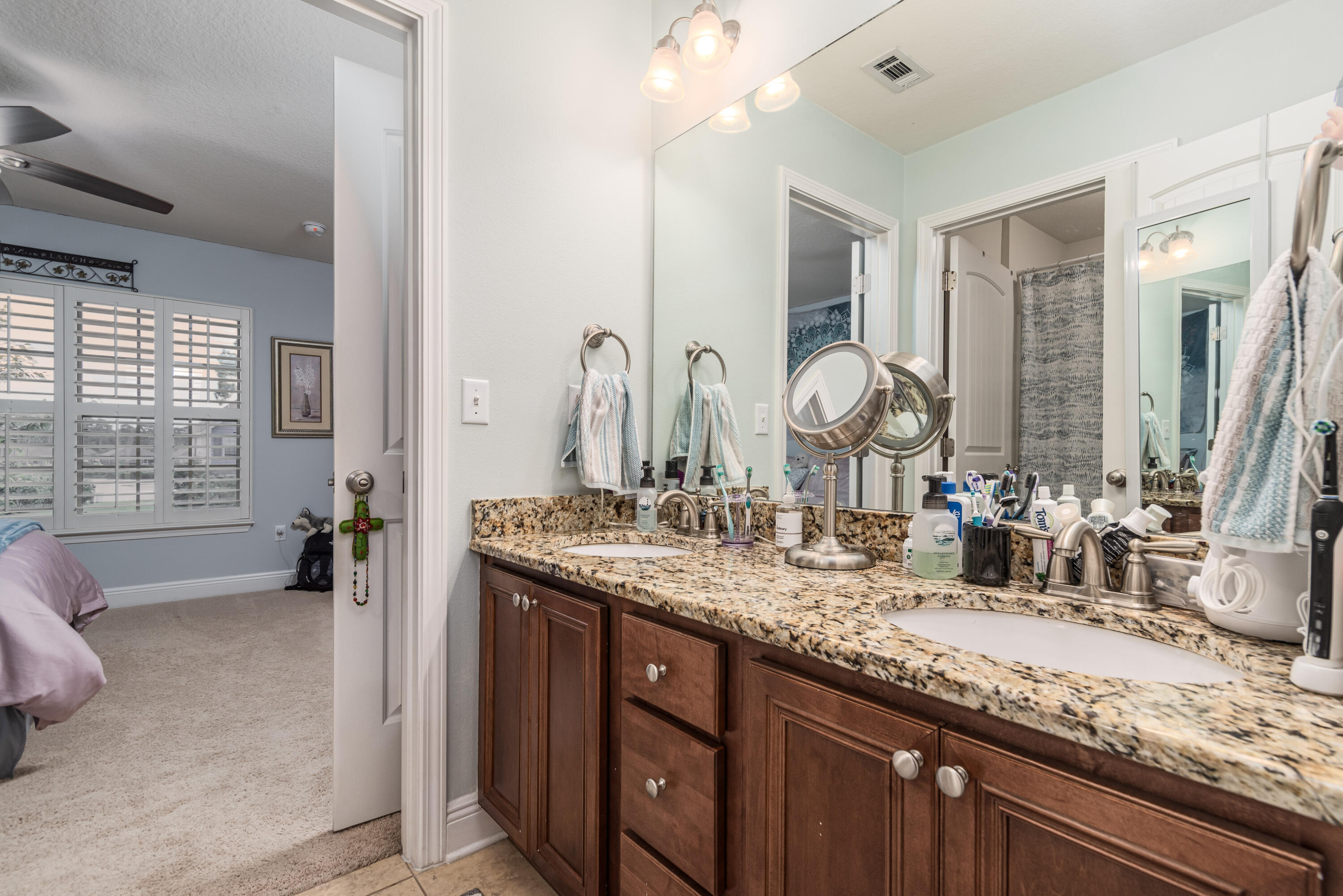 142 Pin Oak Loop Santa Rosa Beach, FL 32459 - Photo 47 of 56 a bathroom with a granite countertop double vanity sink and a mirror