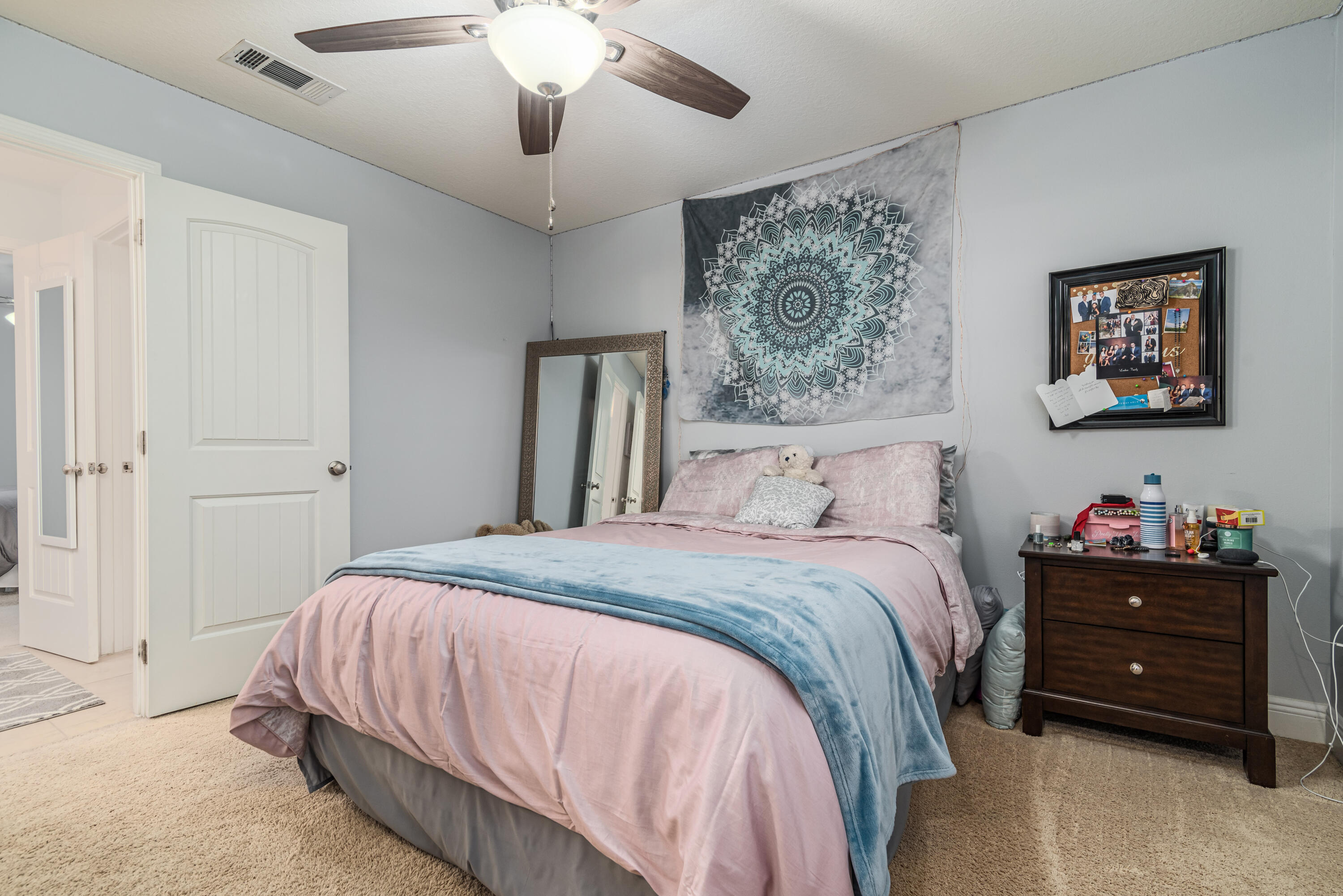 142 Pin Oak Loop Santa Rosa Beach, FL 32459 - Photo 52 of 56 a bedroom with a bed and a chandelier