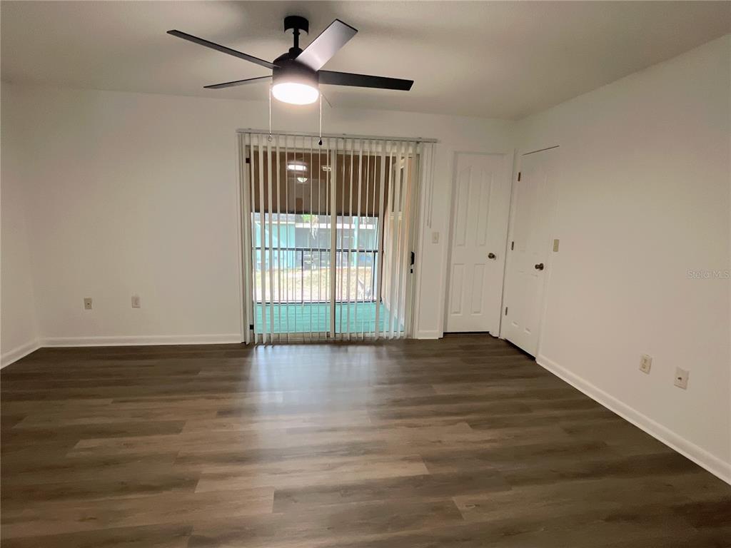 501 Southwest 75th Street, Unit C4 Gainesville, FL 32607 - Photo 11 of 37 a view of an empty room with wooden floor and a window