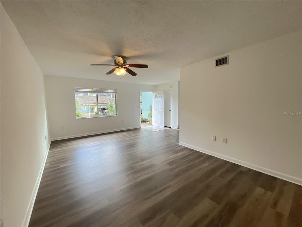 501 Southwest 75th Street, Unit C4 Gainesville, FL 32607 - Photo 14 of 37 an empty room with wooden floor and windows