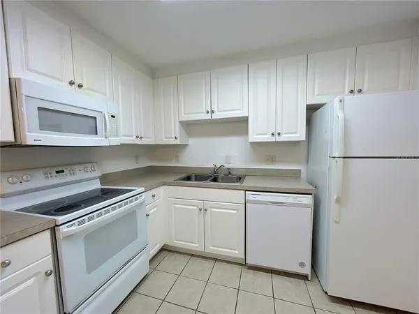 a kitchen with cabinets stainless steel appliances and a sink