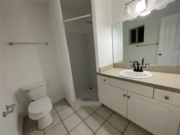 a bathroom with a sink toilet and mirror