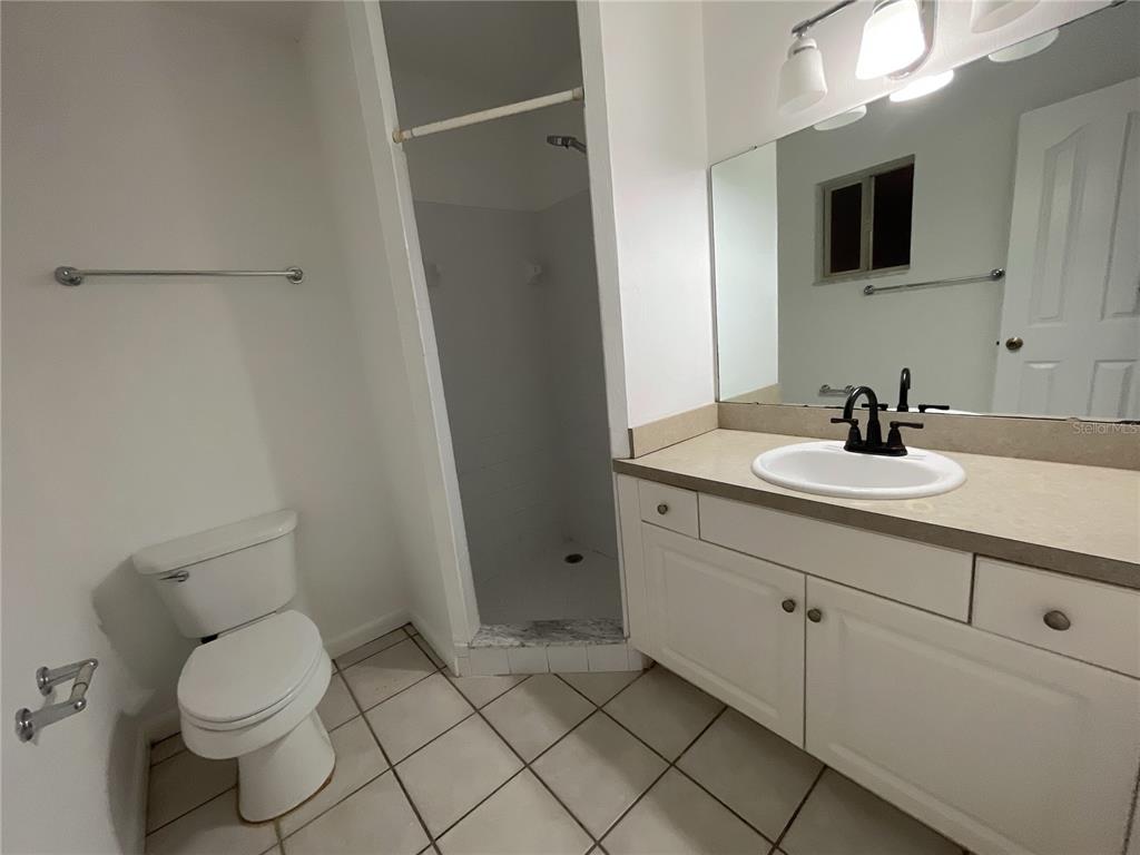 501 Southwest 75th Street, Unit C4 Gainesville, FL 32607 - Photo 25 of 37 a bathroom with a sink toilet and mirror