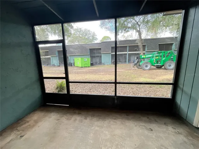 a view of garage with a car parked in it