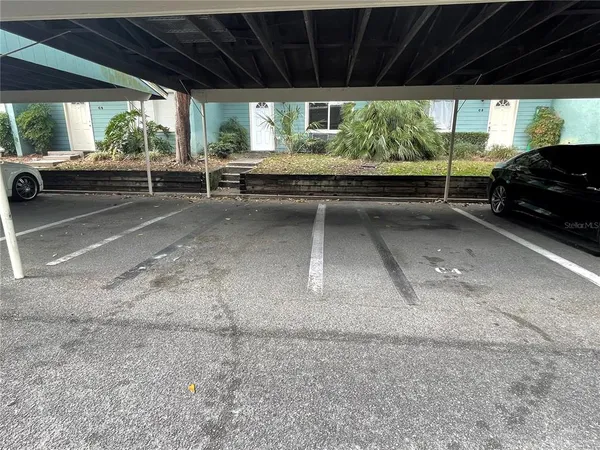 a view of garage with a car parked in it