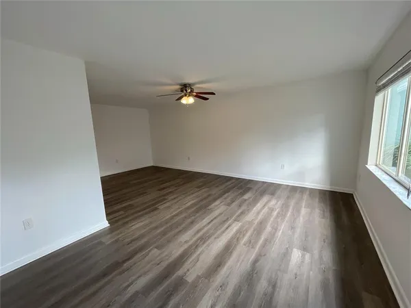 wooden floor in an empty room with a window