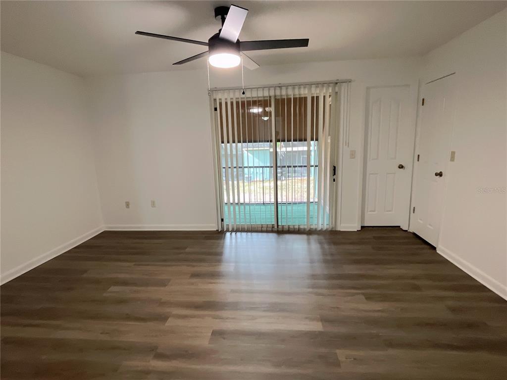 501 Southwest 75th Street, Unit C4 Gainesville, FL 32607 - Photo 10 of 37 a view of an empty room with wooden floor and a window