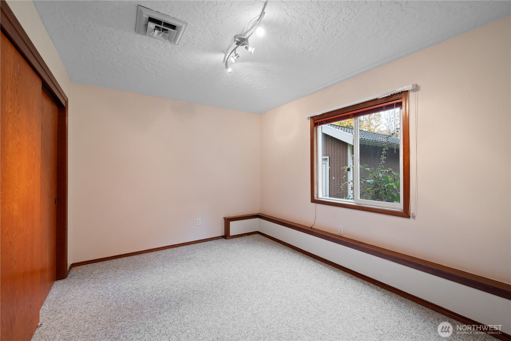 4415 Poplar Way Longview, WA 98632 - Photo 23 of 35 an empty room with a window and a ceiling fan