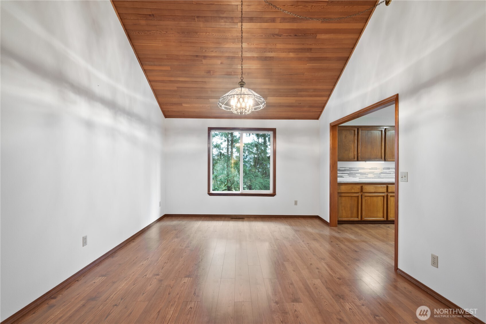 4415 Poplar Way Longview, WA 98632 - Photo 4 of 35 a view of an empty room with wooden floor and a window