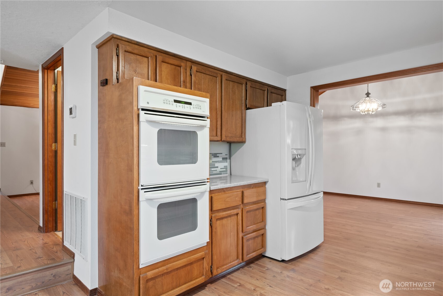 4415 Poplar Way Longview, WA 98632 - Photo 5 of 35 a kitchen with stainless steel appliances a refrigerator sink and cabinets
