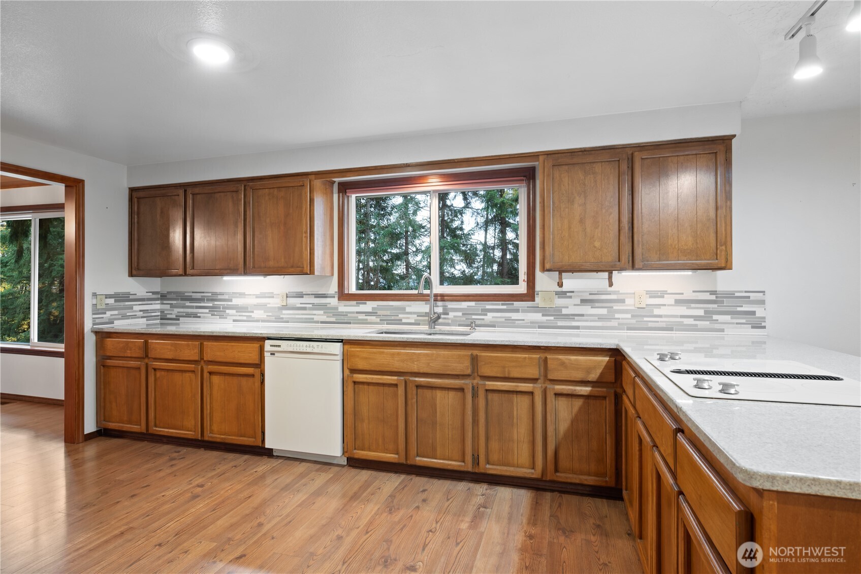 4415 Poplar Way Longview, WA 98632 - Photo 6 of 35 a kitchen with granite countertop wooden cabinets a sink and appliances