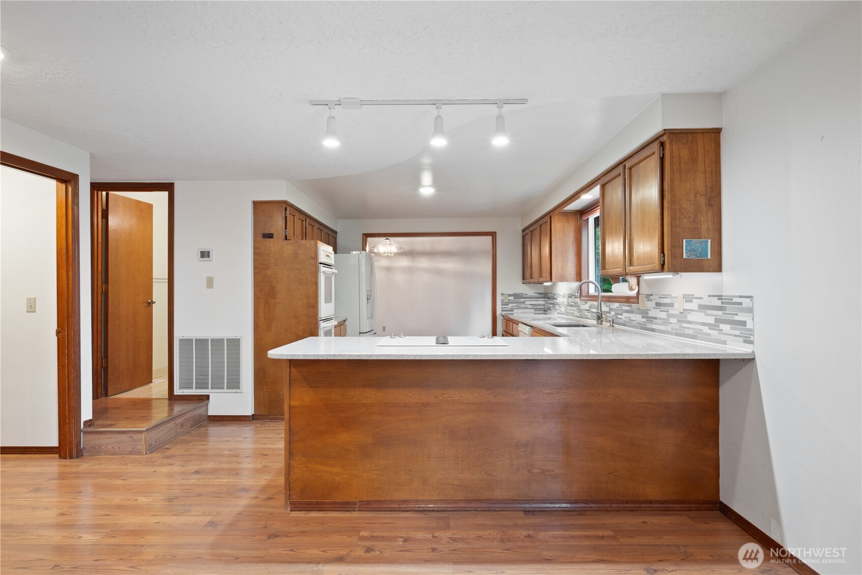 4415 Poplar Way Longview, WA 98632 - Photo 7 of 35 a view of kitchen with stainless steel appliances granite countertop cabinets and window