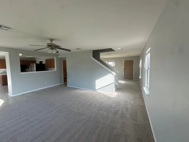 a view of a hallway with wooden floor and kitchen