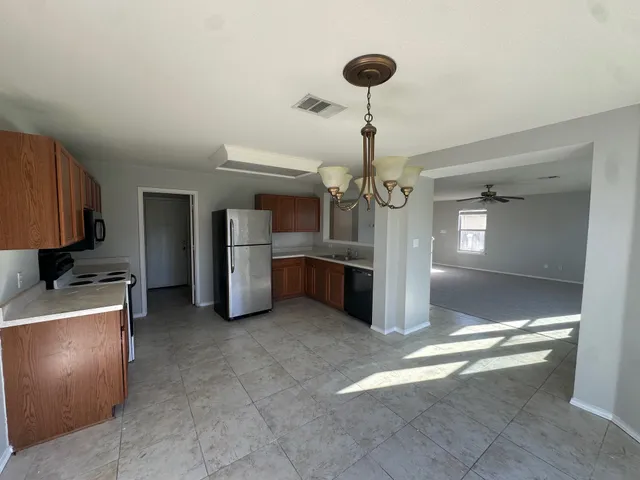 a view of a refrigerator and kitchen in a room