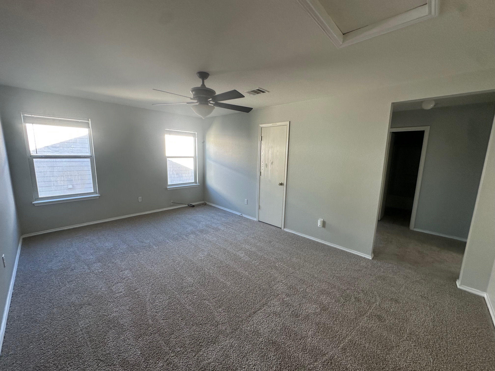 102 Blanco Woods Boulevard Elgin, TX 78621 - Photo 9 of 12 an empty room with windows and ceiling fan