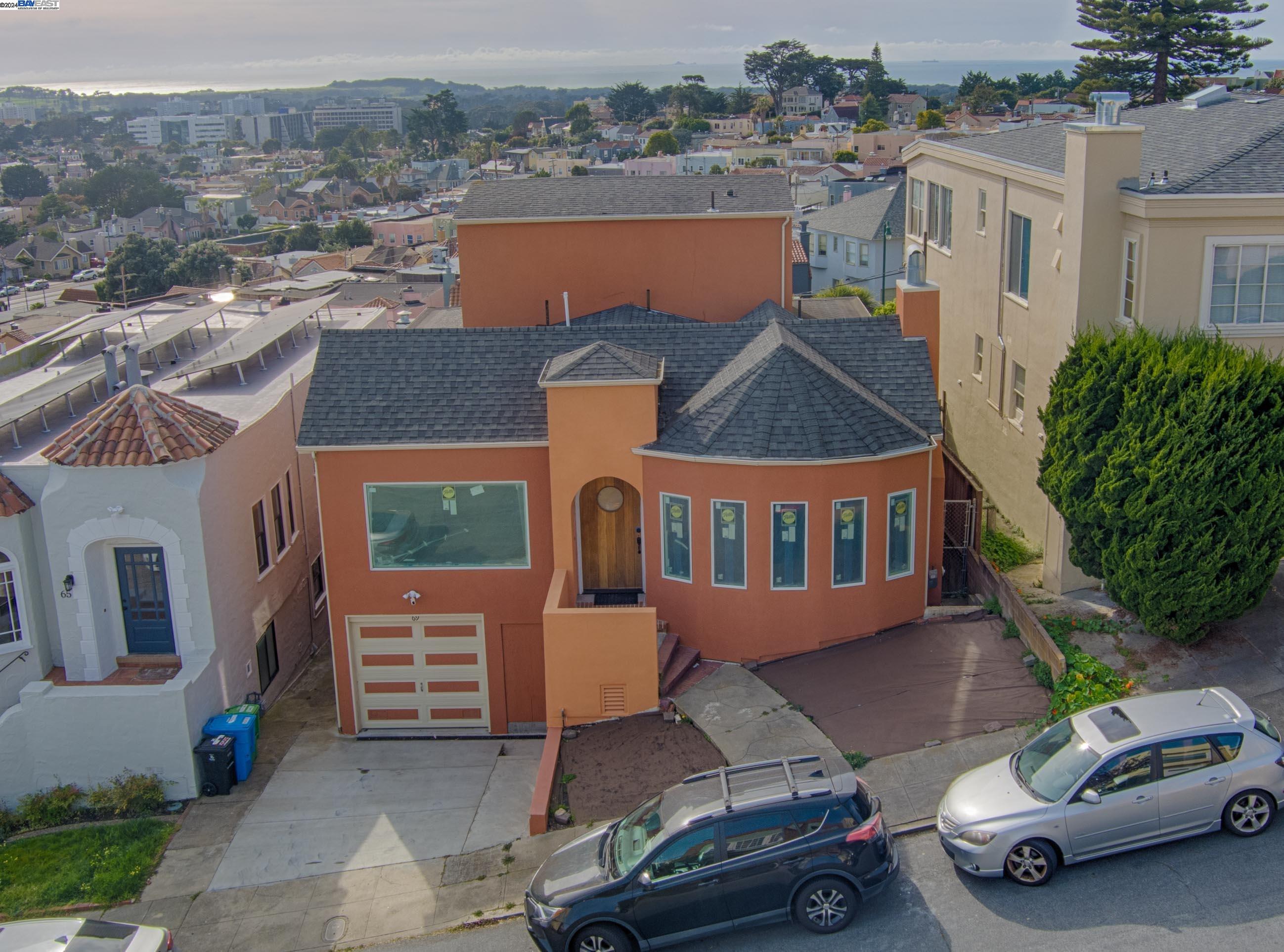 an aerial view of a house with car parked